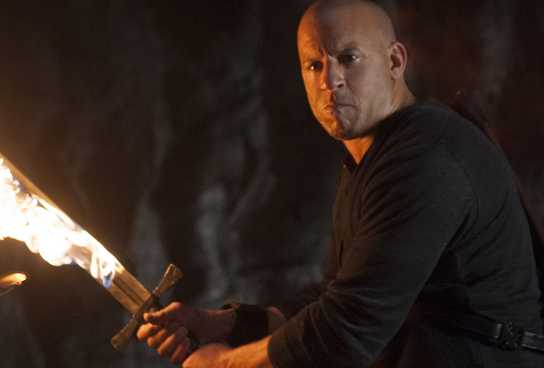 Vin Diesel in The Last Witch Hunter holding a flaming sword